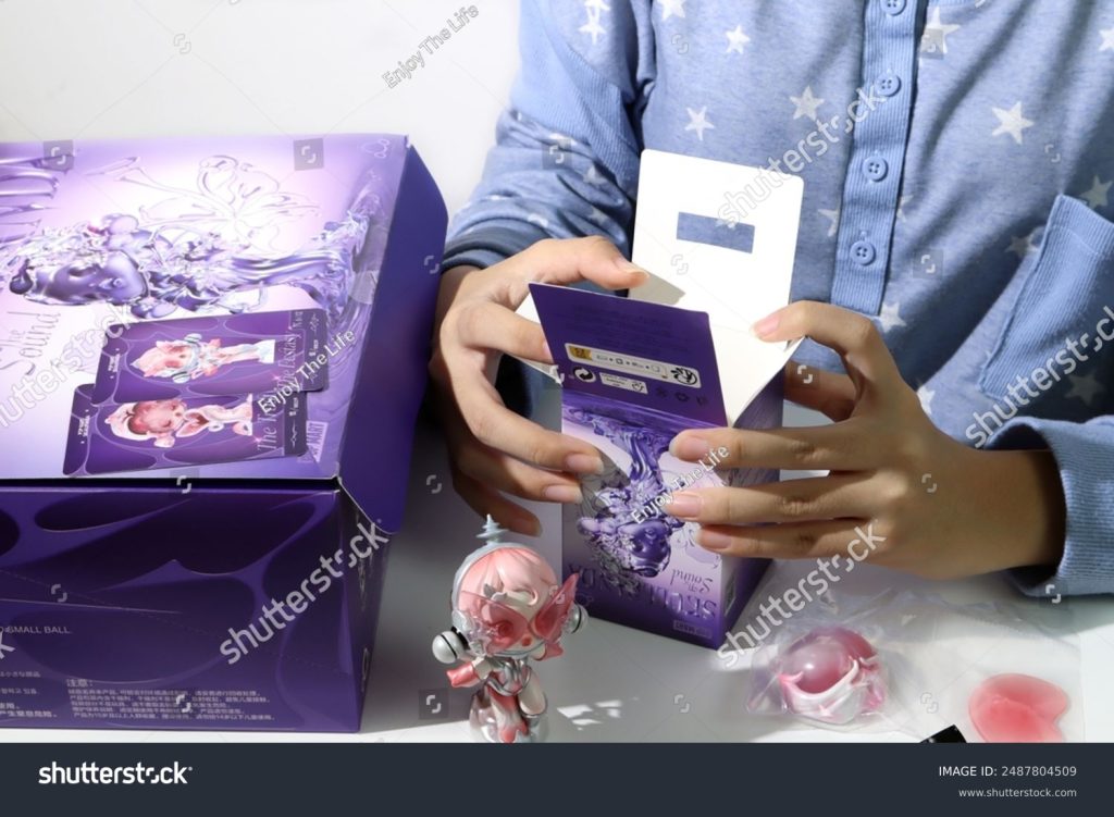 Image of someone unboxing a SKULLPANDA The Sound Blind Box Set from Pop Mart.